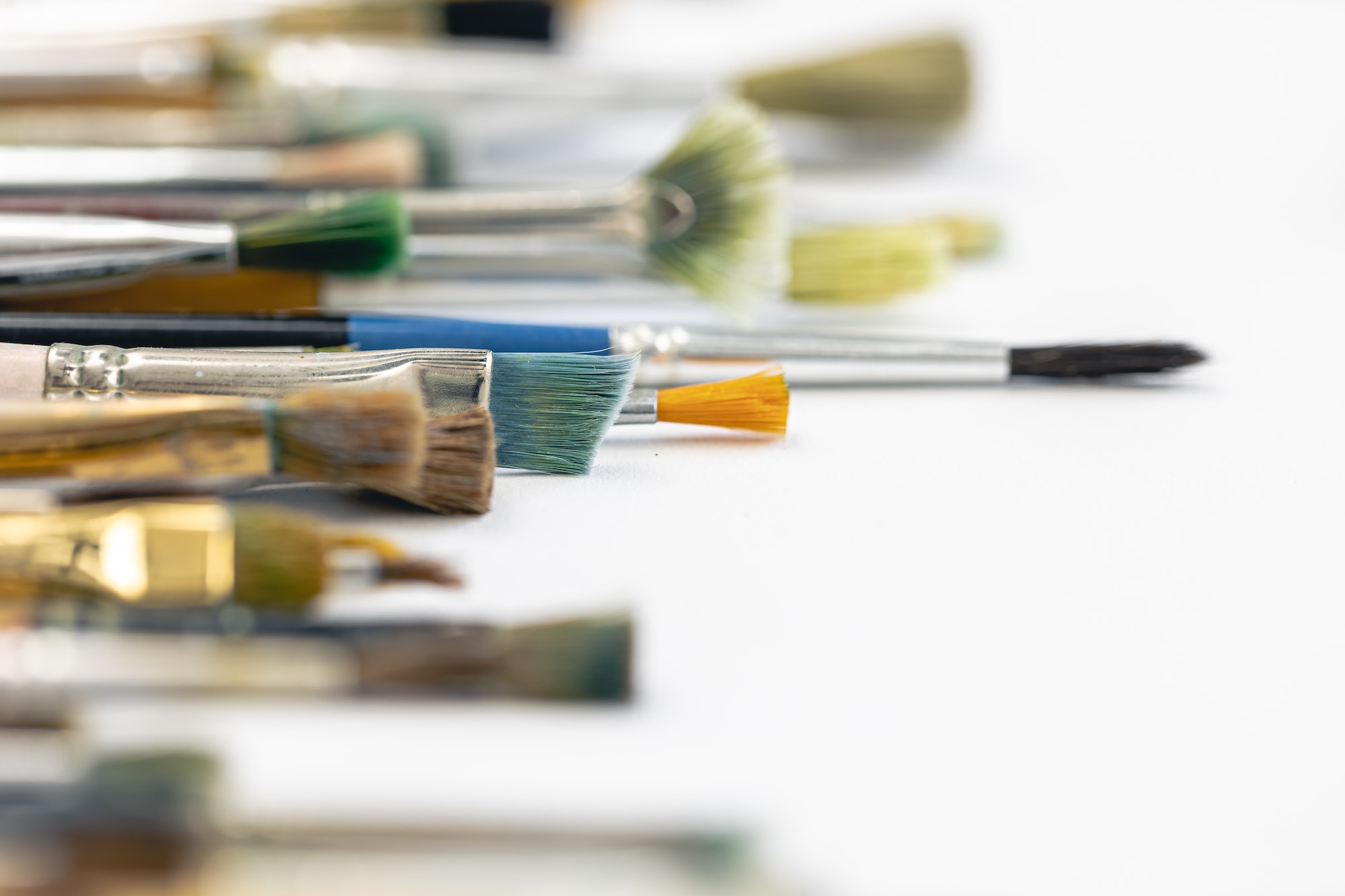 Paint brushes stained with paint, close-up, macro shot.